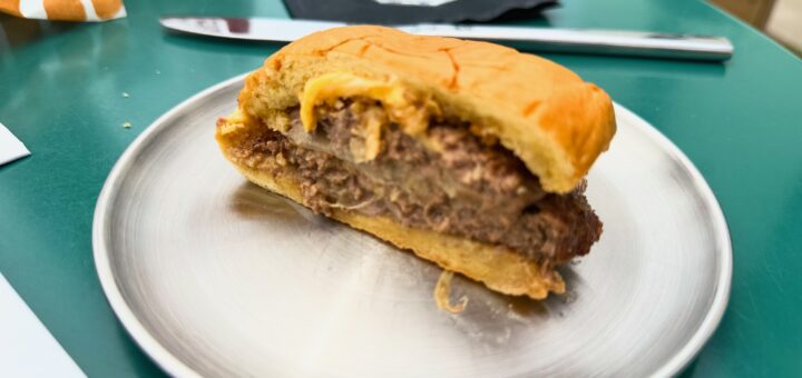 half burger on a metal plate