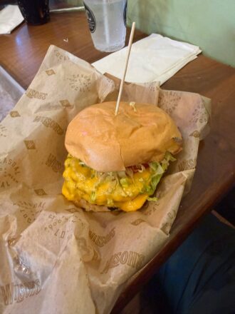 cheeseburger on paper in a basket