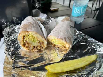 hoagie cut in half on an outdoor table