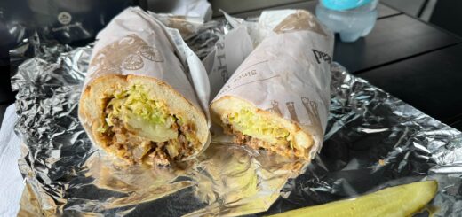 hoagie cut in half on an outdoor table