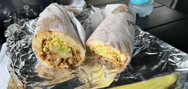 hoagie cut in half on an outdoor table